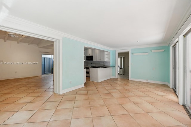 unfurnished living room with ornamental molding, beam ceiling, light tile patterned floors, and a healthy amount of sunlight