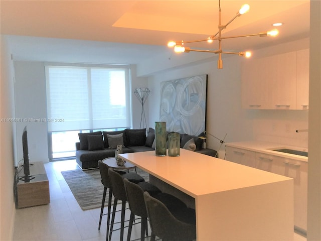 kitchen featuring white cabinets, a center island, and plenty of natural light