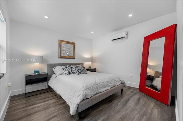 bedroom featuring a wall unit AC and hardwood / wood-style flooring