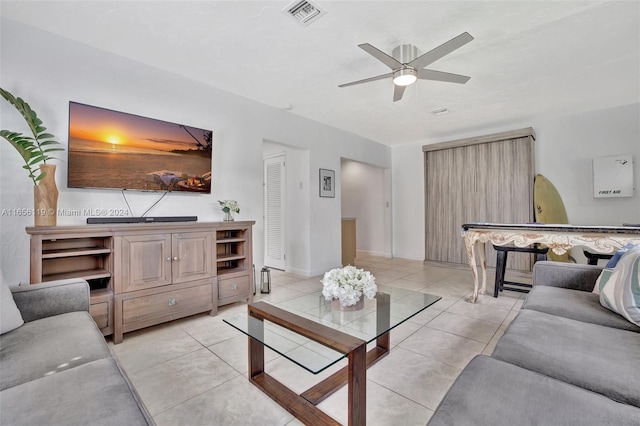 tiled living room with ceiling fan