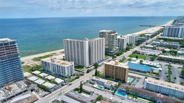 bird's eye view featuring a water view and a beach view