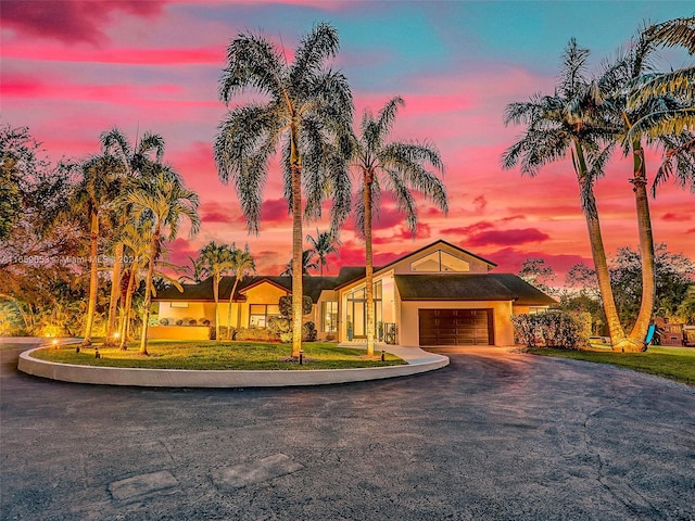 view of front of house with a lawn and a garage