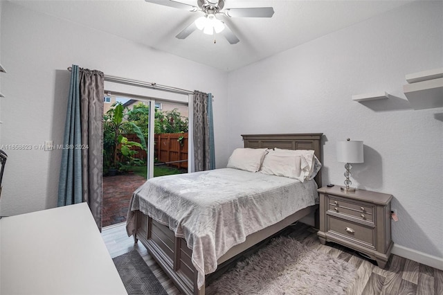 bedroom with ceiling fan, dark hardwood / wood-style floors, and access to outside