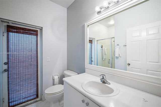 bathroom with vanity, toilet, a shower with curtain, and tile patterned floors