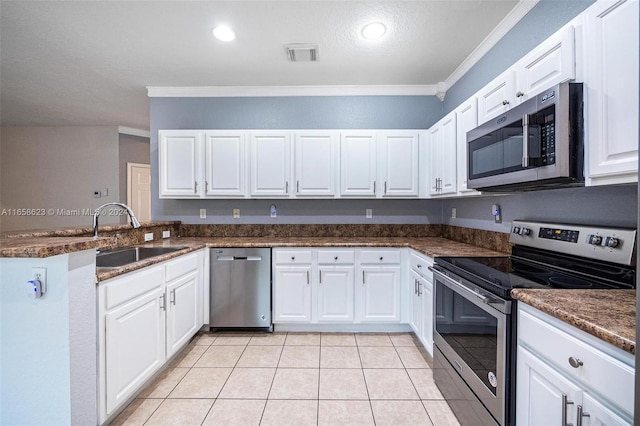 kitchen with stainless steel appliances, sink, and white cabinetry