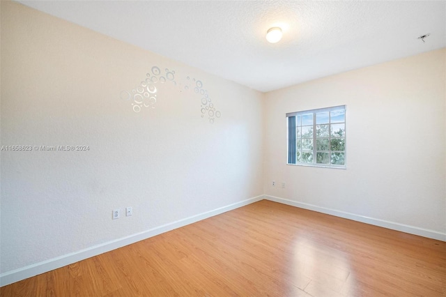 empty room with hardwood / wood-style floors