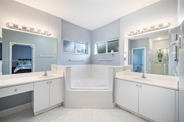 bathroom featuring tile patterned floors, shower with separate bathtub, and vanity