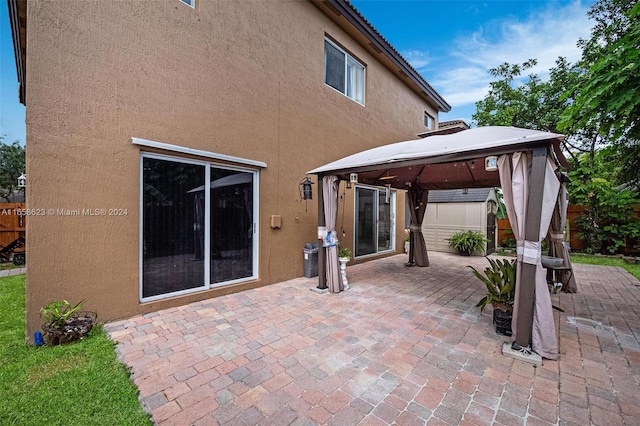 view of patio featuring a shed and a gazebo