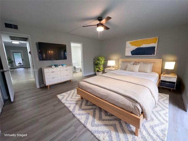 bedroom with connected bathroom, wood-type flooring, and ceiling fan