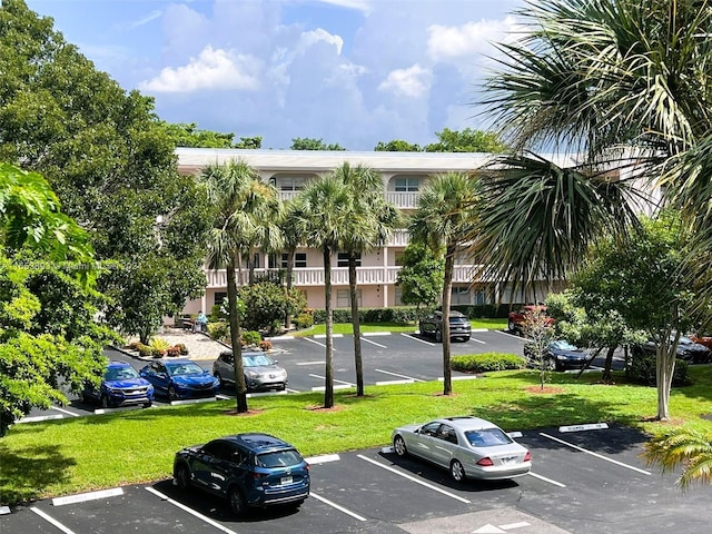 view of parking with a yard