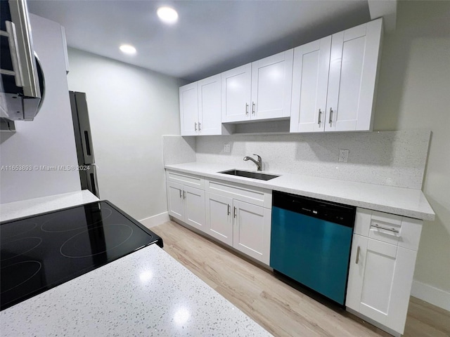 kitchen with white cabinetry, stainless steel appliances, and sink