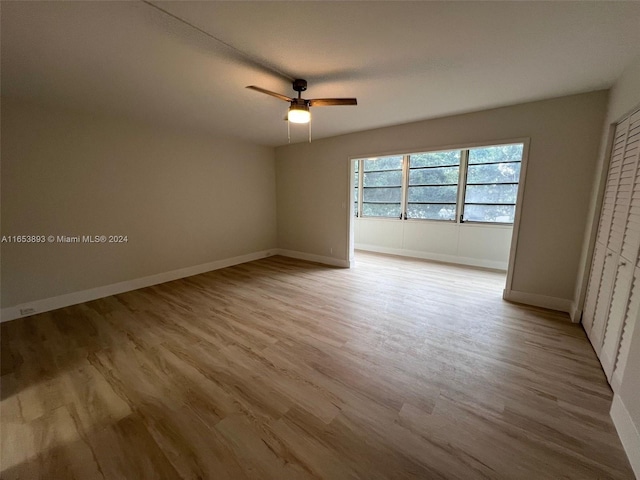 unfurnished bedroom with a closet, ceiling fan, and light wood-type flooring