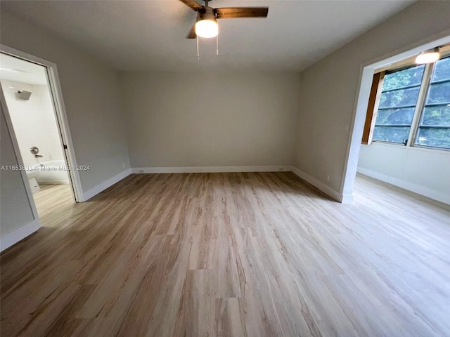 empty room featuring light hardwood / wood-style flooring and ceiling fan