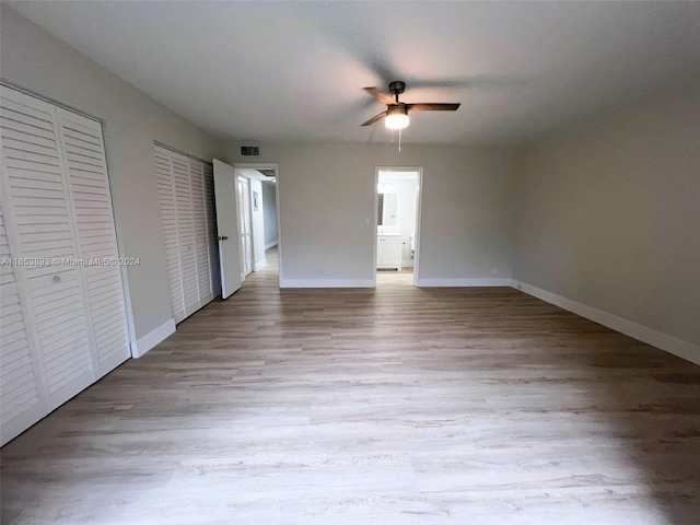 2002 Granada Dr Unit J3, Coconut Creek, FL 33066 - unfurnished bedroom with two closets, a ceiling fan, visible vents, baseboards, and wood finished floors