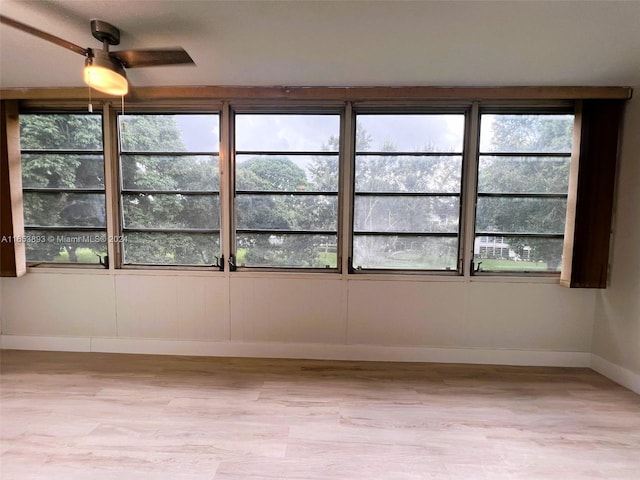 unfurnished room featuring light hardwood / wood-style floors, plenty of natural light, and ceiling fan