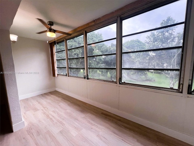 empty room featuring light wood-type flooring and ceiling fan