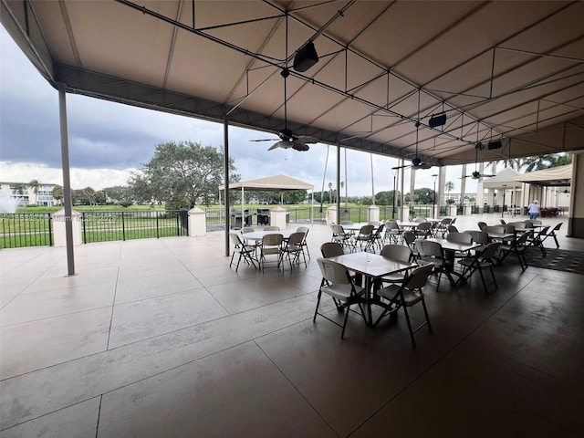 2002 Granada Dr Unit J3, Coconut Creek, FL 33066 - view of patio / terrace featuring fence, outdoor dining space, and a ceiling fan