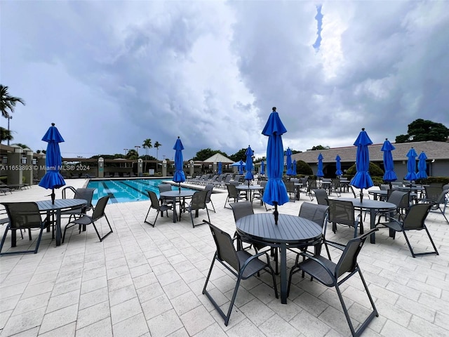 2002 Granada Dr Unit J3, Coconut Creek, FL 33066 - view of patio / terrace featuring outdoor dining area and a community pool