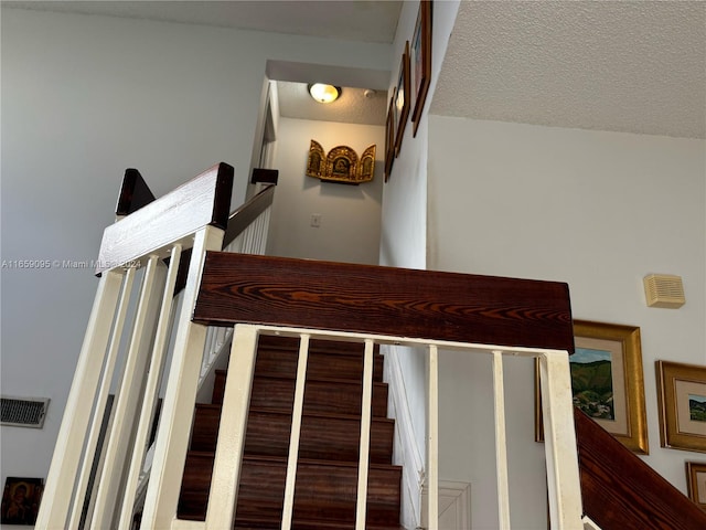 stairway with a textured ceiling