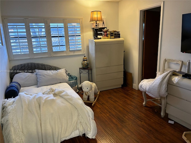 bedroom with dark hardwood / wood-style floors