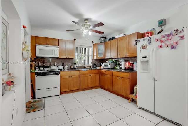 kitchen featuring light tile patterned floors, white appliances, sink, ceiling fan, and tasteful backsplash