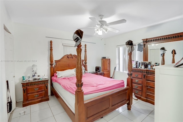 tiled bedroom featuring ceiling fan