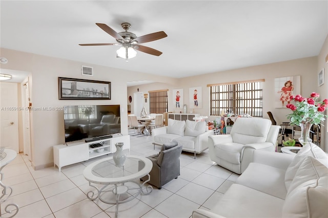 living room with ceiling fan and light tile patterned flooring