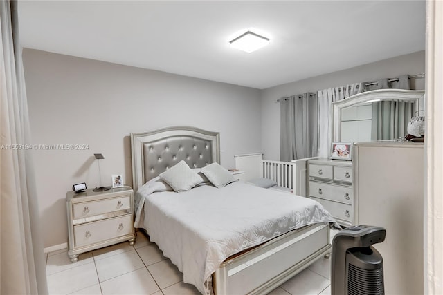 bedroom with light tile patterned floors