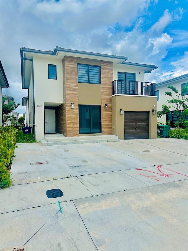 modern home featuring a balcony and a garage