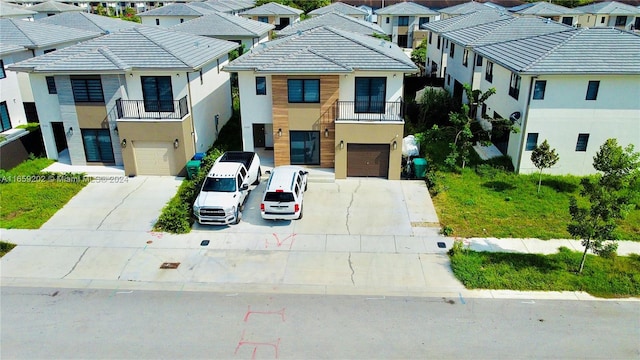 view of front of house featuring a balcony and a garage