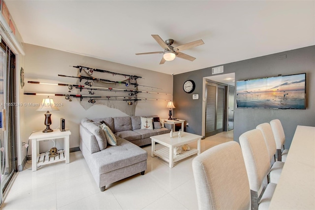 tiled living room with ceiling fan