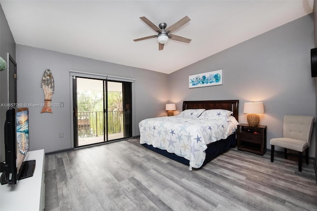 bedroom featuring hardwood / wood-style floors, ceiling fan, access to exterior, and vaulted ceiling