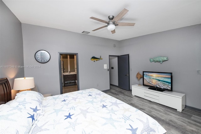 bedroom featuring dark wood-type flooring, ensuite bathroom, and ceiling fan