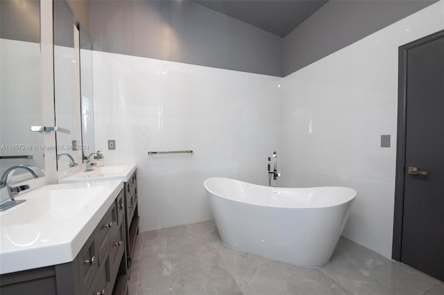 bathroom featuring vanity, tile walls, and a bathing tub