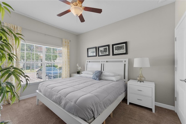 bedroom featuring ceiling fan and dark colored carpet