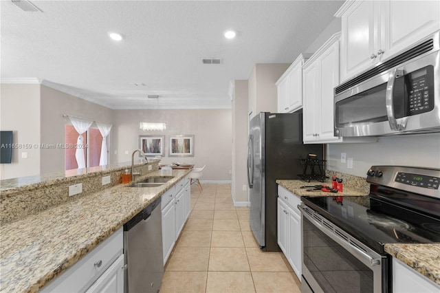 kitchen featuring white cabinets, light stone countertops, stainless steel appliances, and sink