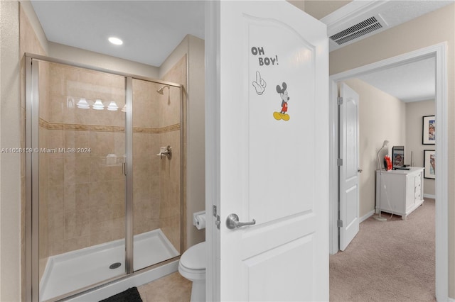 bathroom with an enclosed shower and toilet