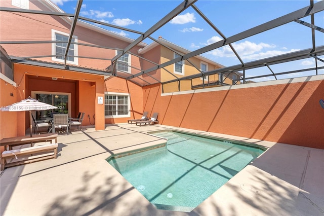 view of swimming pool with a lanai and a patio