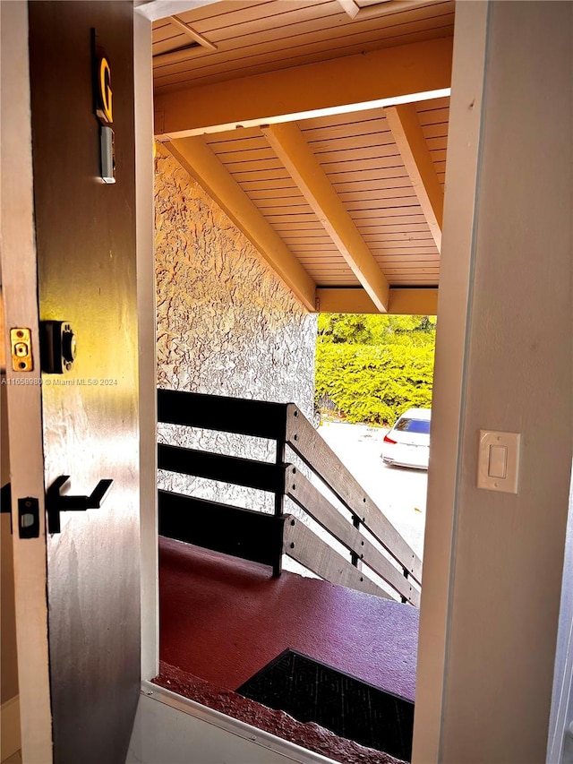 doorway featuring wood ceiling and beamed ceiling