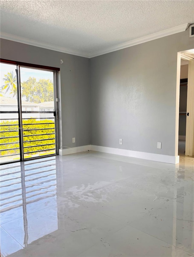 spare room with a textured ceiling and crown molding