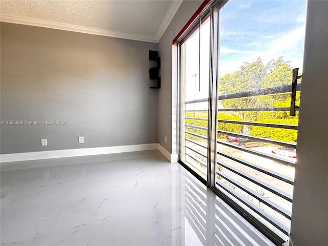 empty room featuring crown molding and a textured ceiling