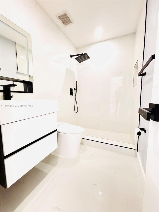 bathroom with vanity, toilet, and walk in shower