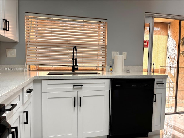 kitchen with dishwasher, sink, and white cabinets