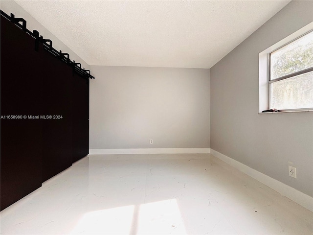 spare room with concrete flooring and a textured ceiling