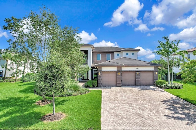 view of front of property featuring a front lawn and a garage