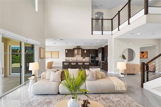 living room featuring light tile patterned flooring and a high ceiling