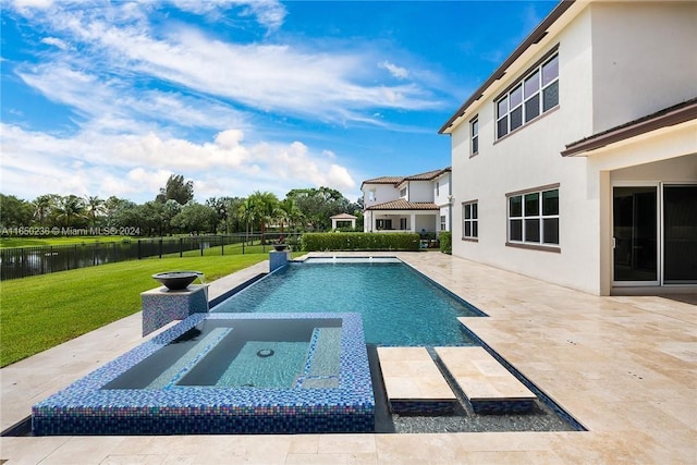 view of swimming pool with a patio area, a yard, a water view, and an in ground hot tub