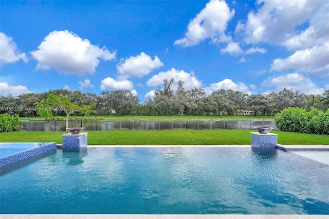 view of swimming pool with a water view and a lawn