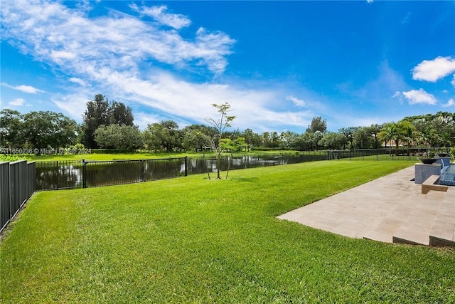 view of yard featuring a patio area and a water view