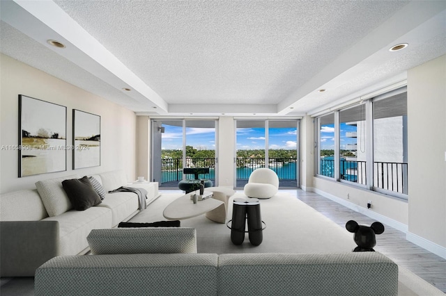 living room with a textured ceiling and light hardwood / wood-style flooring